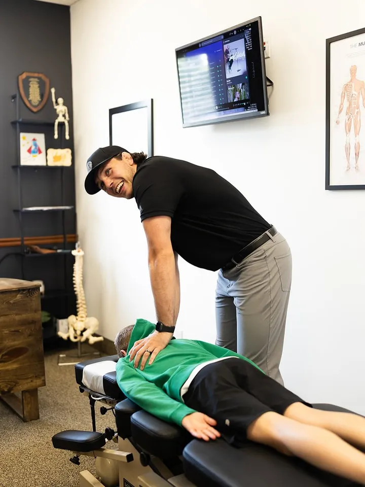 A patient being adjusted in a Tribe treatment room