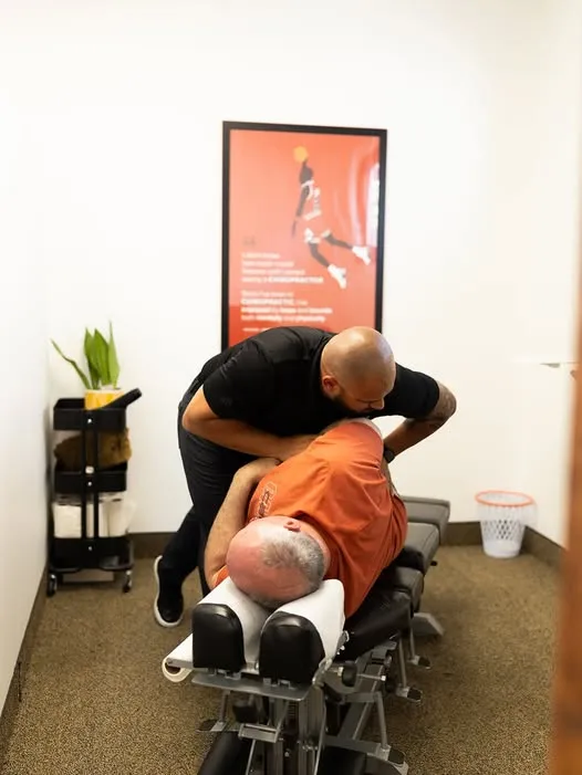 A patient receiving a neck adjustment