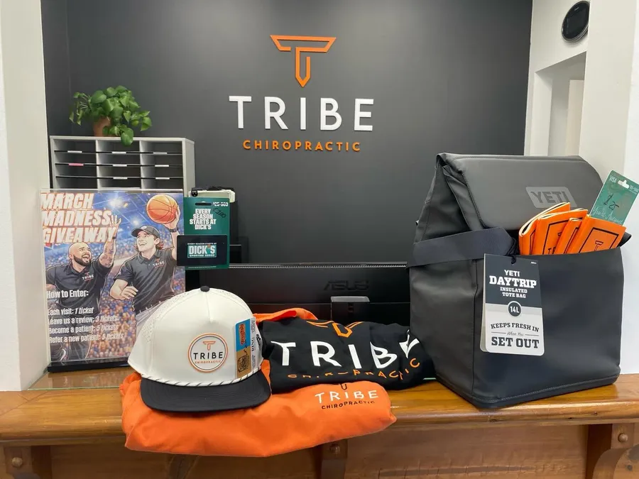 The Tribe Chiropractic front desk with branded merch